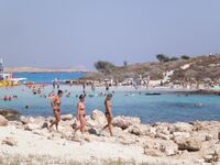 She Walks Through Shallow Water in Pink Bikini Bottoms
