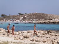 She Walks Through Shallow Water in Pink Bikini Bottoms