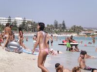 She Walks Through Shallow Water in Pink Bikini Bottoms