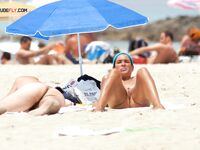 A lady finding her own rhythm with the tide at a clothing-optional beach.