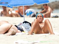 A lady finding her own rhythm with the tide at a clothing-optional beach.