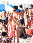 A lady finding her own rhythm with the tide at a clothing-optional beach.