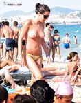 A lady finding her own rhythm with the tide at a clothing-optional beach.