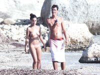 Nude Woman and Towel-Wrapped Man at a Nudist Beach