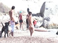Nude Woman and Towel-Wrapped Man at a Nudist Beach