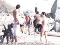 Nude Woman and Towel-Wrapped Man at a Nudist Beach