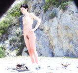 Nude Woman and Towel-Wrapped Man at a Nudist Beach