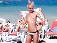 Topless Beach Moment Beside Loungers and Umbrellas