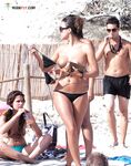 A Leisurely Sandy Walk — Topless Woman and Beaded Necklace