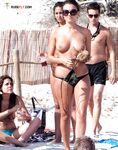 A Leisurely Sandy Walk — Topless Woman and Beaded Necklace