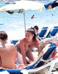 A Leisurely Sandy Walk — Topless Woman and Beaded Necklace