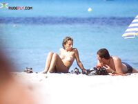 A collection of candid moments at a beach where being topless is the tradition.