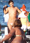 A lady enjoying the tranquility of the coast in a natural topless fashion.