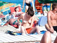 My wife getting her beautiful breasts and hard nipples tanned on the strand.