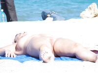 Sitting Topless by the Shoreline with Knees Drawn Up