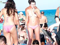 A lady enjoying the ultimate sunbathing experience at a clothing-optional spot.