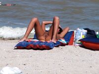 Sunbathing on a Red and Blue Air Mattress at a Nude Beach