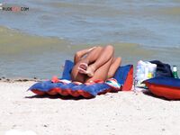 Sunbathing on a Red and Blue Air Mattress at a Nude Beach