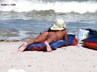 Sunbathing on a Red and Blue Air Mattress at a Nude Beach
