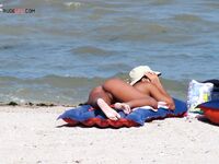 Sunbathing on a Red and Blue Air Mattress at a Nude Beach