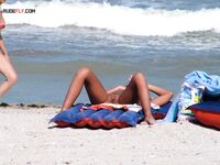 Sunbathing on a Red and Blue Air Mattress at a Nude Beach