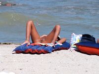 Sunbathing on a Red and Blue Air Mattress at a Nude Beach