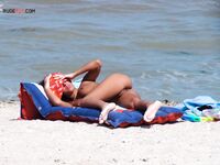 Sunbathing on a Red and Blue Air Mattress at a Nude Beach