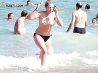 A lady enjoying the tranquility of the coast in a natural topless fashion. 2