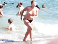 A lady enjoying the tranquility of the coast in a natural topless fashion. 2