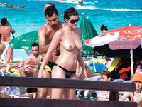 Busy Beach Pose Under Sunlit Umbrellas on a Warm Shore