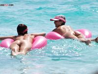 The simple life: bare feet in the sand and the sun on a topless, relaxed chest. 2