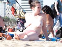 . Capturing the radiant glow of a sun-lover at a clothing-free beach.