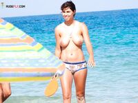 Bright Summer Paddleball for a Topless Woman by the Ocean