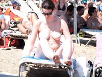 She Walks Through the Water at a Busy Topless Beach