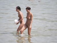Ready for Volleyball Near a White Ball on the Sand