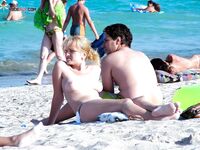 Sandy Shoreline Nude Beach Walk with Shoulder Tattoo
