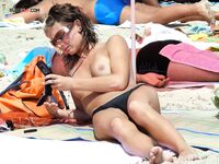 Basking in the soft evening light, enjoying the tranquility of a beautiful nude beach.