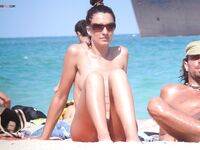 A woman enjoying the solitude of a hidden beach in a completely nude state.