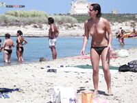 Shoreline Nudist Beach Stroll with Water Droplets on Skin