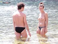 Shoreline Nudist Beach Stroll with Water Droplets on Skin