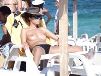 Capturing the aesthetic of a topless afternoon at a private coastal resort.