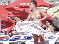 Capturing the aesthetic of a topless afternoon at a private coastal resort.