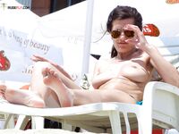 Topless Sunbathing Under a Clear Blue Sky
