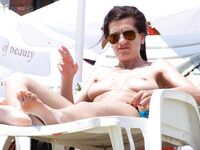 Topless Sunbathing Under a Clear Blue Sky