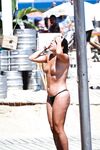 Two Topless Women Chatting by Clear Blue Water