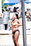 Two Topless Women Chatting by Clear Blue Water