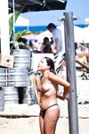 Two Topless Women Chatting by Clear Blue Water