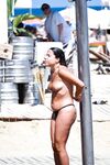Two Topless Women Chatting by Clear Blue Water