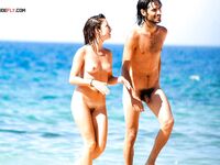 A lady enjoying the rhythmic sound of the waves in a relaxed, clothing-free manner.