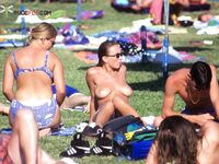 One Woman Topless on the Beach with a Green Towel